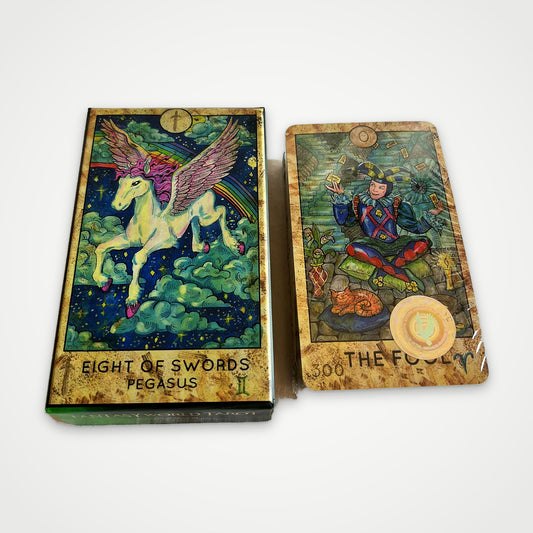 Fantasy World Tarot printed box with Eight of Swords Pegasus next to the shrink-wrapped deck with The Fool on top