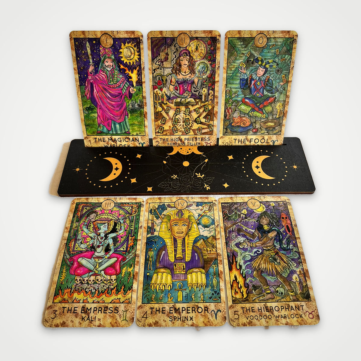 Fantasy World Tarot cards on a wooden stand: The Magician, The High Priestess, The Fool, The Empress, The Emperor, The Hierophant