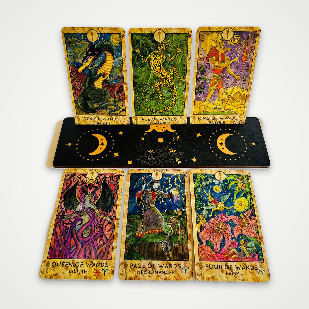 Fantasy World Tarot Wands cards on a wooden stand: Ten, Ace, King, Queen, Page and Four of Wands