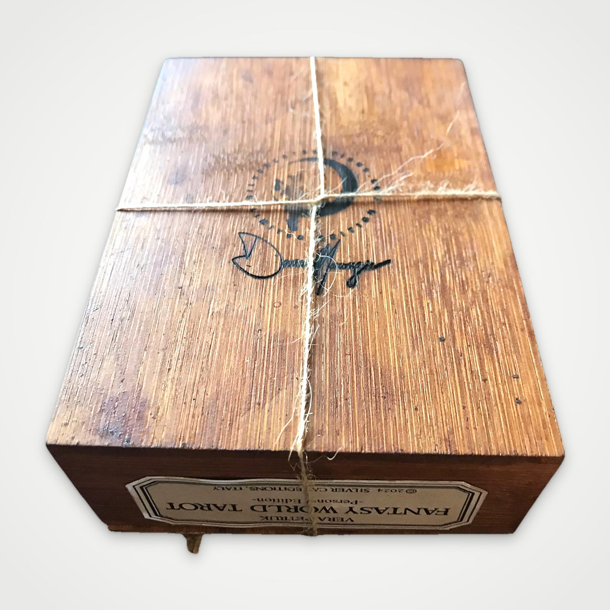 Back of the Fantasy World Tarot handmade wooden box tied with twine, with the Silver Cat Editions logo burned into the wood