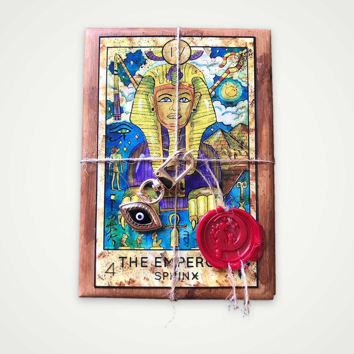 Top view of the Fantasy World Tarot wooden box with The Emperor Sphinx lid, twine, wax seal and evil eye charm
