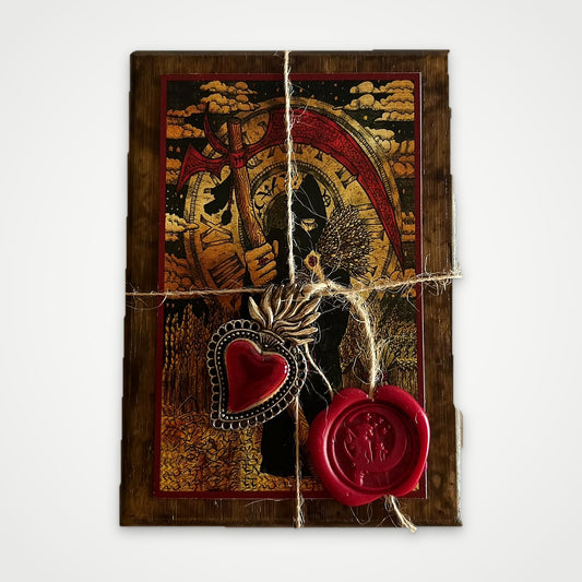 Top view of the brown wooden box with the Scythe artwork, twine, red wax seal and silver heart charm