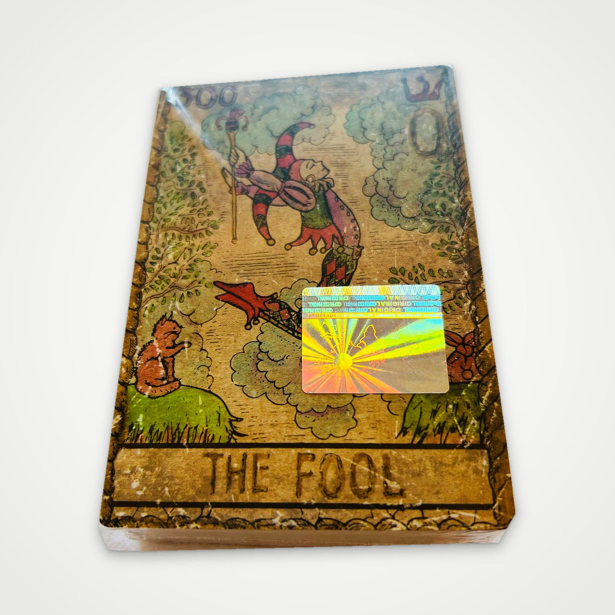 Samiramay Tarot deck in shrink wrap with The Fool on top and a holographic authenticity sticker